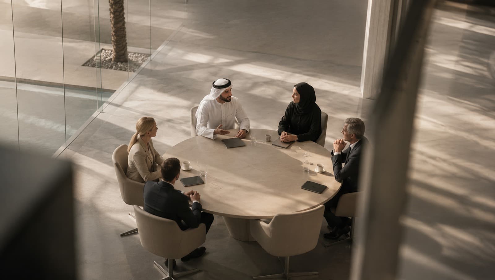 Five people in discussion around a meeting table