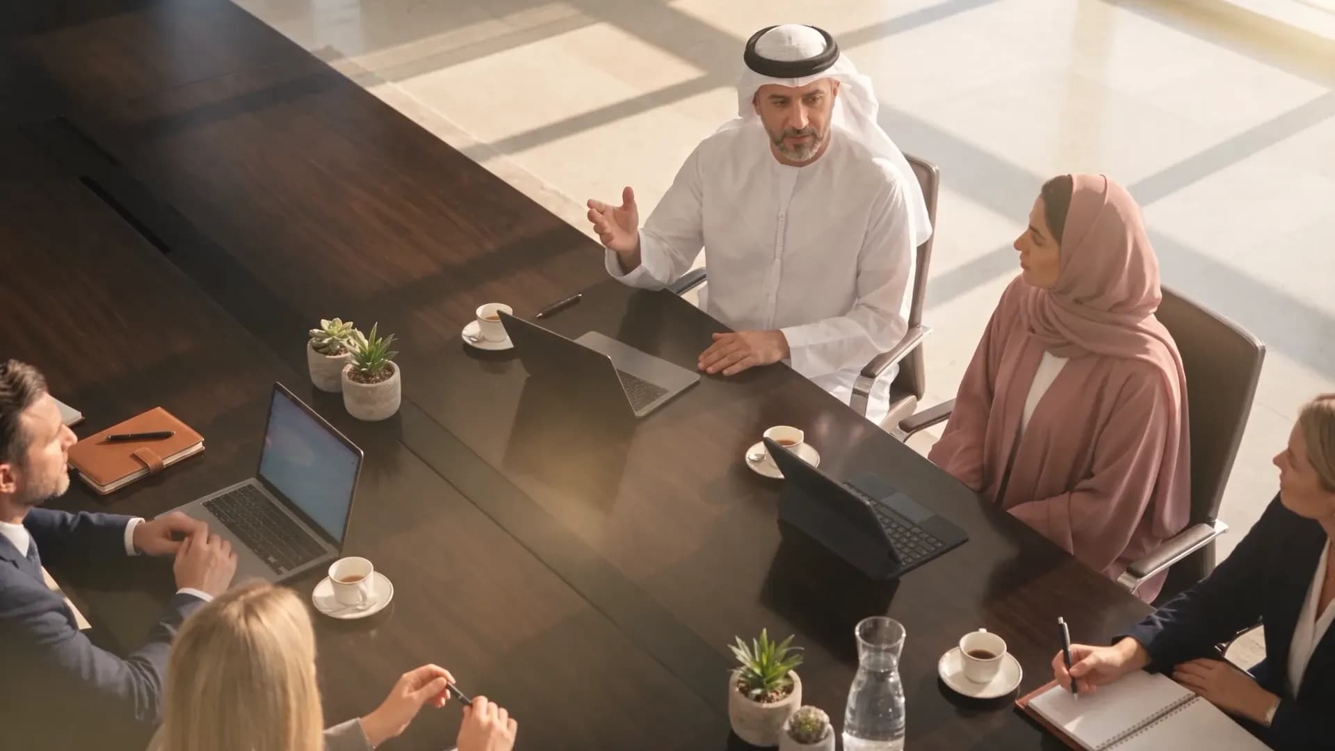 Business leaders in discussion around a boardroom table.